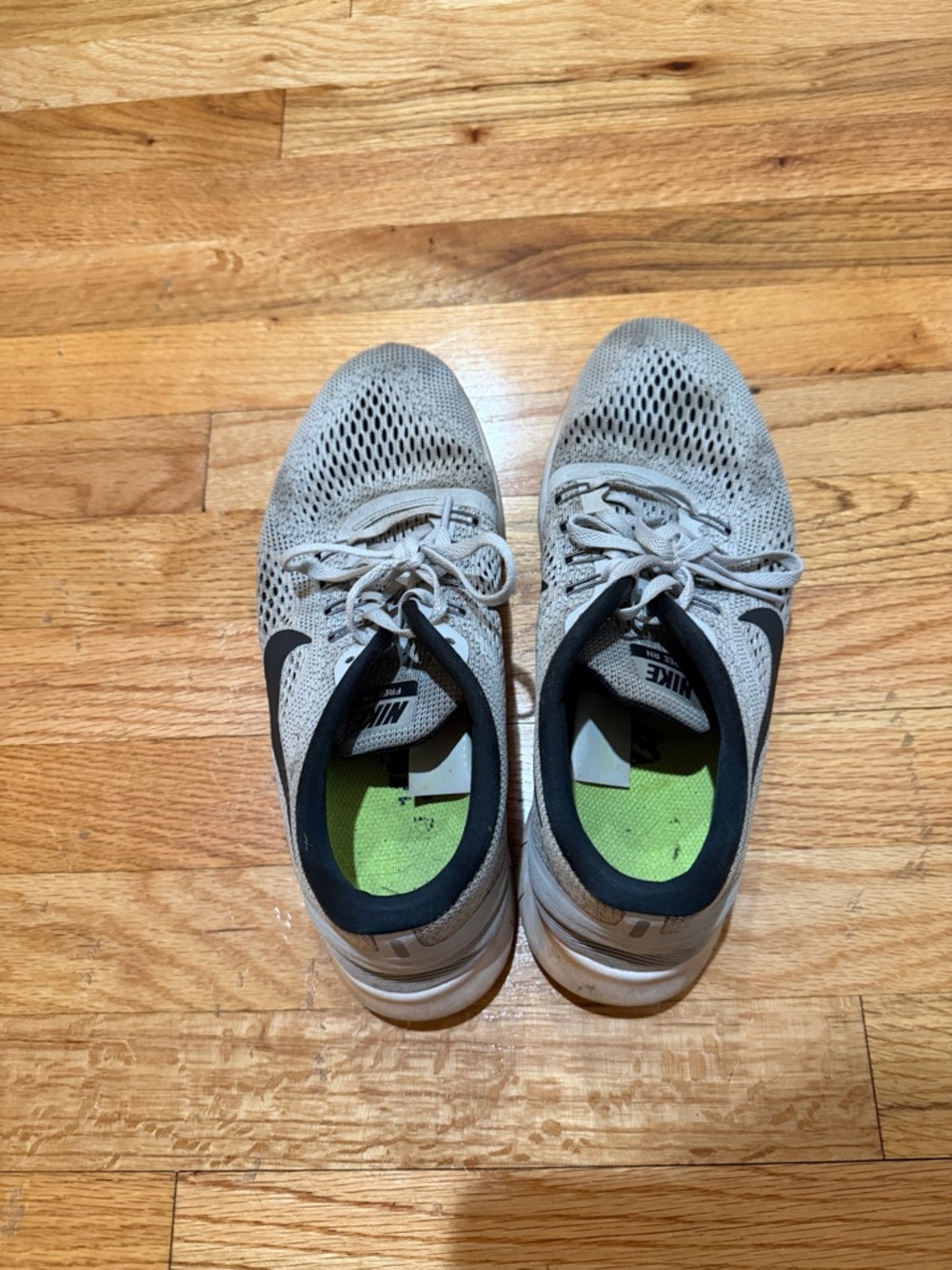 Nike Women’s Light Gray Athletic Shoes with Black Swoosh